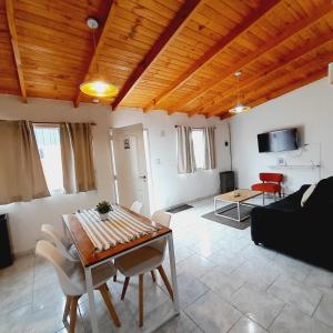 a living room with a table and a couch at Ayres del Sur Patagonia I Departamento N 2 in Río Gallegos +5 photos