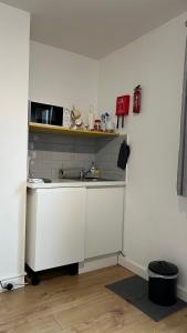 a kitchen with a sink and a microwave at Hawtհorn Guestհouse in Cambridge