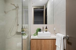 a bathroom with a sink and a shower at Forbes Manaa Living in Perth +54 photos