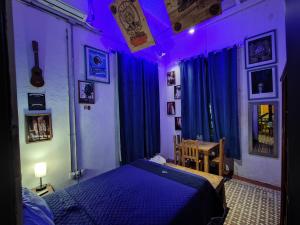 Postel nebo postele na pokoji v ubytování Chuchumbé Hotel & Hostal