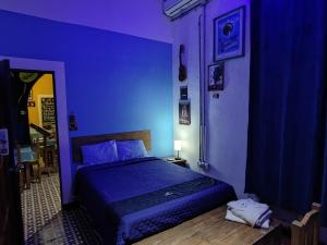 Postel nebo postele na pokoji v ubytování Chuchumbé Hotel & Hostal