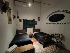 Postel nebo postele na pokoji v ubytování Chuchumbé Hotel & Hostal