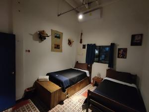 Postel nebo postele na pokoji v ubytování Chuchumbé Hotel & Hostal