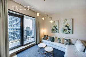 a living room with a couch and a large window at Sparkle Tower, Dubai Marina in Dubai