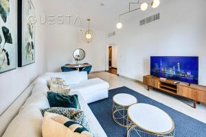 a living room with a couch and a tv at Sparkle Tower, Dubai Marina in Dubai +42 photos