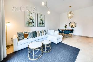 a living room with a couch and two tables at Sparkle Tower, Dubai Marina in Dubai