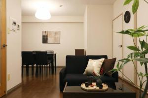 a living room with a black couch and a table at キャピタルジン熱海202 in Atami +36 photos