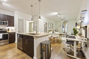 a large kitchen with a sink and a dining room at Sleeps 8 2B near Legacy West Toyota & The Star 2250 in Frisco