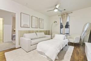 a living room with white furniture and a couch at Sleeps 8 2B near Legacy West Toyota & The Star 2250 in Frisco +50 photos