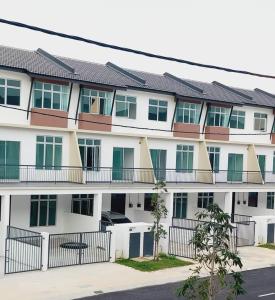 an apartment building with green doors and balconies at Azzahra Homestay Scientex Kundang Jaya Rawang in Pengkalan Kundang