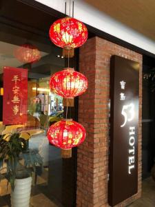 a group of red lanterns hanging from a store window at 53 Hotel in Taichung
