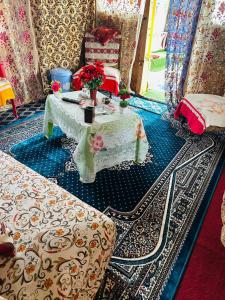 a room with a table with flowers on it at H.B Rocket paradise in Srinagar