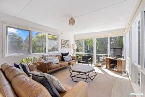 a living room with a couch and a tv at Cowes On Hill in Cowes