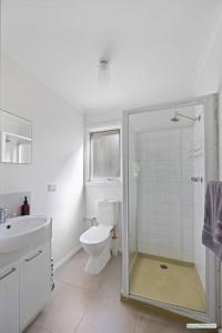 a bathroom with a shower and a toilet and a sink at Cowes On Hill in Cowes