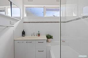a white bathroom with a sink and a shower at Cowes On Hill in Cowes +20 photos