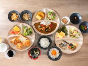 a group of plates of food on a table at Super Hotel Ueno-Okachimachi in Tokyo