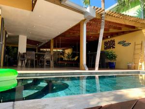 a swimming pool in front of a house at Villa Zélie, avec piscine et proche du lagon in La Saline Les hauts 