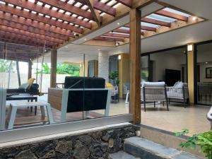 a living room with a view of a patio at Villa Zélie, avec piscine et proche du lagon in La Saline Les hauts 