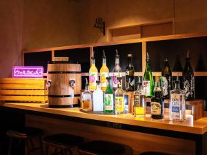 a bar with a lot of bottles of alcohol at Super Hotel Ueno-Okachimachi in Tokyo