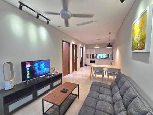 a living room with a couch and a table at Apartment Sky by MonoSuites KLCC in Kuala Lumpur