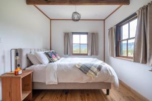 Giường trong phòng chung tại 'Casuarina' - Picturesque Kangaroo Valley Cottage