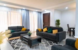 a living room with two couches and a table at Amazing Junior Suite Space Available in Accra