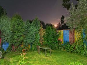 a table sitting in the grass in a garden at night at Shamus Javed Homestay in Srinagar