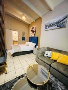 a living room with a couch and a bed at Stunning spacious Studio apartment in Sandton +10 photos