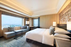 a hotel room with a bed and a couch at Cerulean Tower Tokyu Hotel, A Pan Pacific Partner Hotel in Tokyo