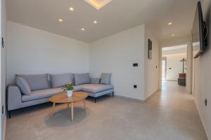 ArtCotel Luxury Villa في مدينة ريثيمنو: غرفة معيشة بها أريكة وطاولة