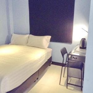 A bed or beds in a room at The Mix Bangkok - Phrom Phong