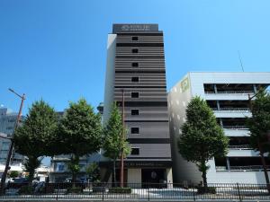a building with a sign on the side of it at HOTEL SUI HAMAMATSU by ABEST in Hamamatsu