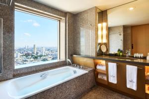 a bathroom with a tub and a large window at Cerulean Tower Tokyu Hotel, A Pan Pacific Partner Hotel in Tokyo