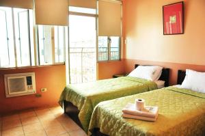 Postel nebo postele na pokoji v ubytování GV Tower Hotel