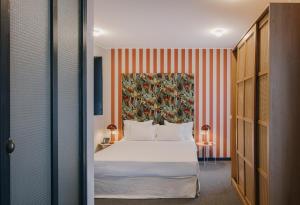 a hotel room with a bed and a painting on the wall at Margot Sololaki in Tbilisi City