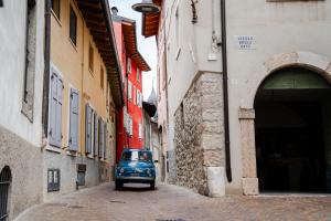 an old blue car driving down a alley at Casaorti Olio Design in Arco