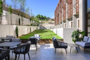 a patio with tables and chairs on a building at INNSiDE by Meliá Braga Centro in Braga
