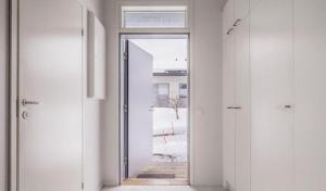 an empty hallway with a door open to a room at Cozy and modern apartment in Luoma