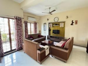 a living room with a couch and a tv at Family fun 2 BHK spacious house in Trivandrum