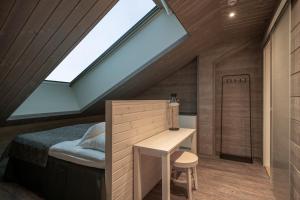 a bedroom with a bed and a skylight at Ski-Inn Kultakero Penthouse in Pelkosenniemi