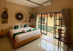 a bedroom with a bed and a large window at Sampai Villa Sahara in Yogyakarta