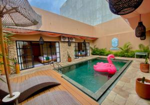 a swimming pool with a pink swan in a house at Sampai Villa Sahara in Yogyakarta