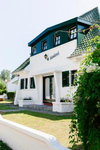 a large white building with a sign on it at Villa Westland in Koksijde