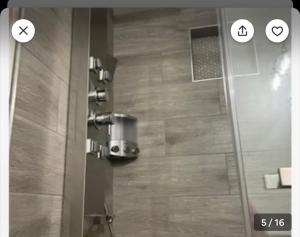 a shower with a glass door in a bathroom at Villa New Place in Las Vegas