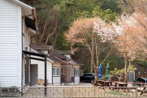 a house with a picnic table in front of it at hongcheon river view sonamu pension in Hongcheon