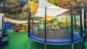 a play area with a trampoline in a building at Gapyeong Tiamo Kids Poolvilla in Kwanch'ŏng-ni +13 photos