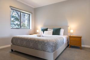 a bedroom with a large bed and a window at Park View in Margaret River Town