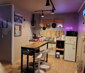 a small kitchen with a table and chairs in it at Donghae Mookhoae Pension in Donghae