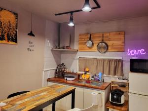 a kitchen with a table and a counter top at Donghae Mookhoae Pension in Mukho-dong