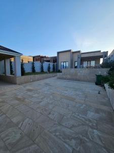 a stone patio in front of a house at Mardakan Villa in Əzizbǝyov